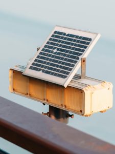 Close-up of a solar panel mounted on a metal support outdoors in daylight.